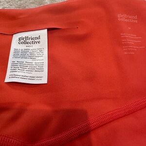 Girlfriend Collective compression bike shorts. Size M. Orange.